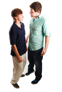 one person trying to intimidate another person by standing too close