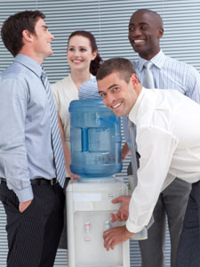 People laughing and talking at water cooler